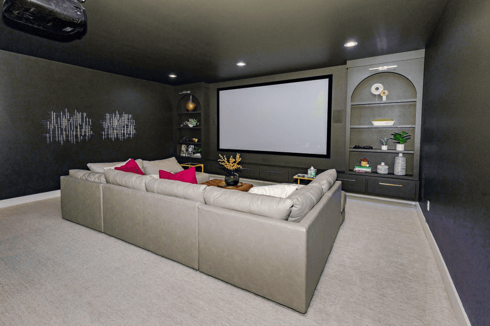 The same media room repainted charcoal, furniture and art untouched