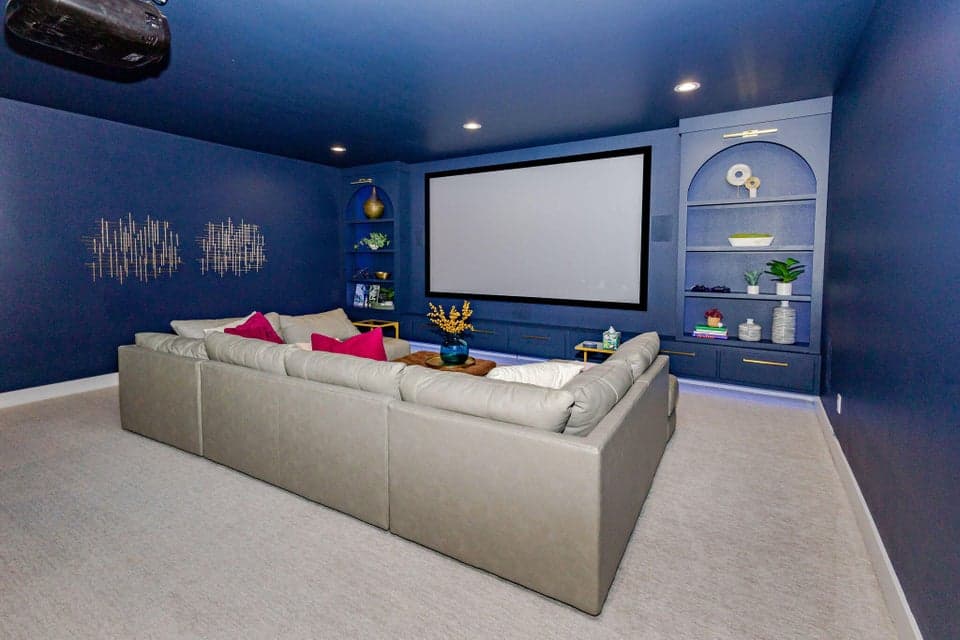 Media room with bold navy walls before the Paint Color enhancement